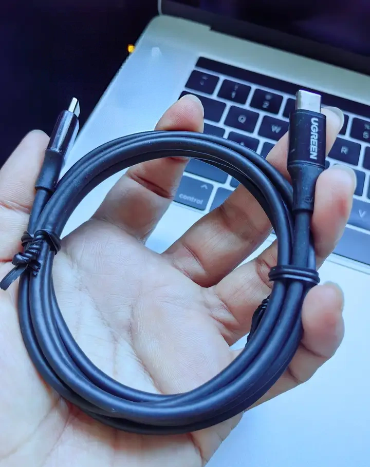 compact GaN charger next to power adapter